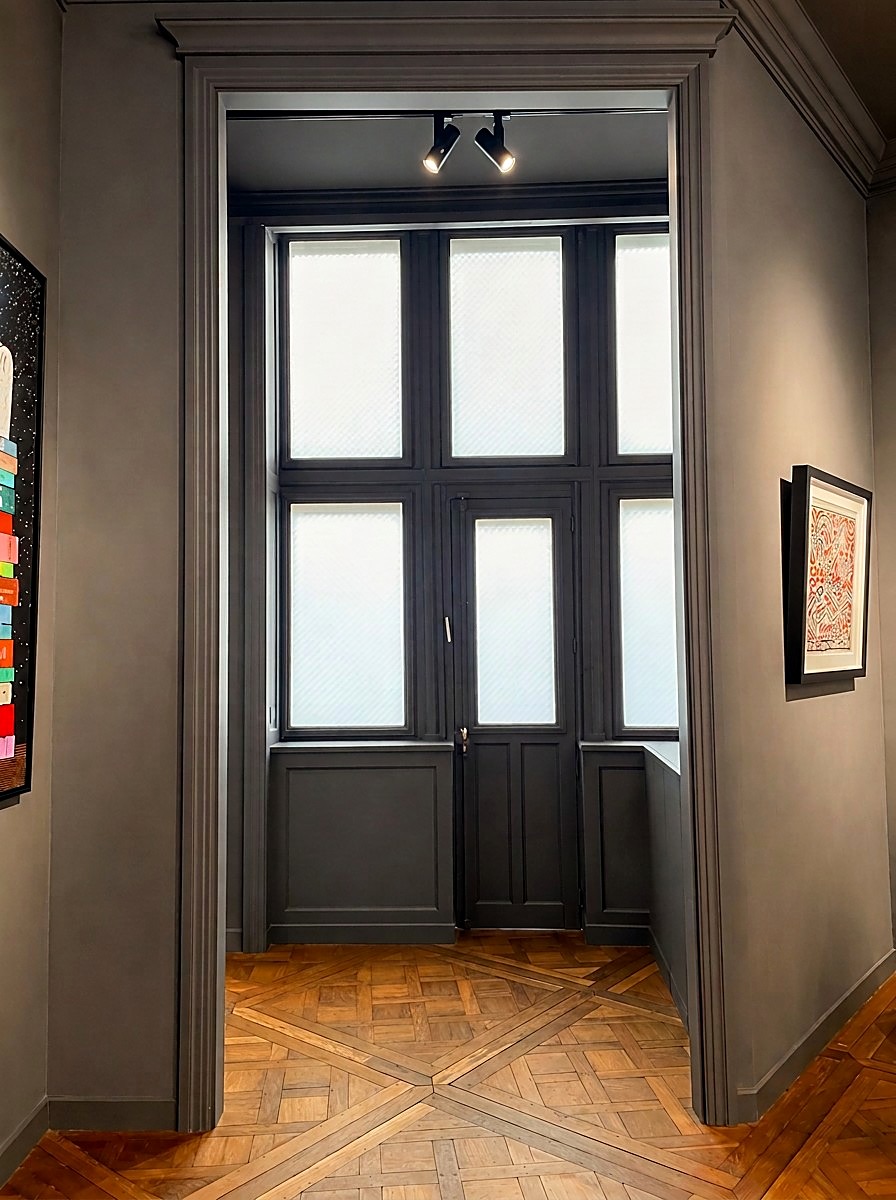 The back room with its glazed window and parquet de Versailles, with artworks