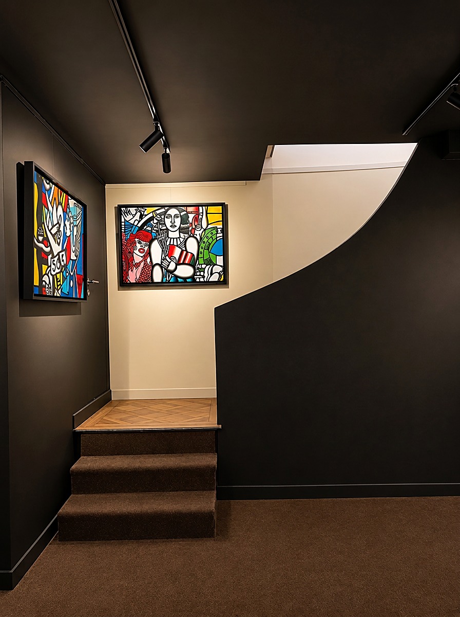 The stairs leading down to the lower level, with artworks